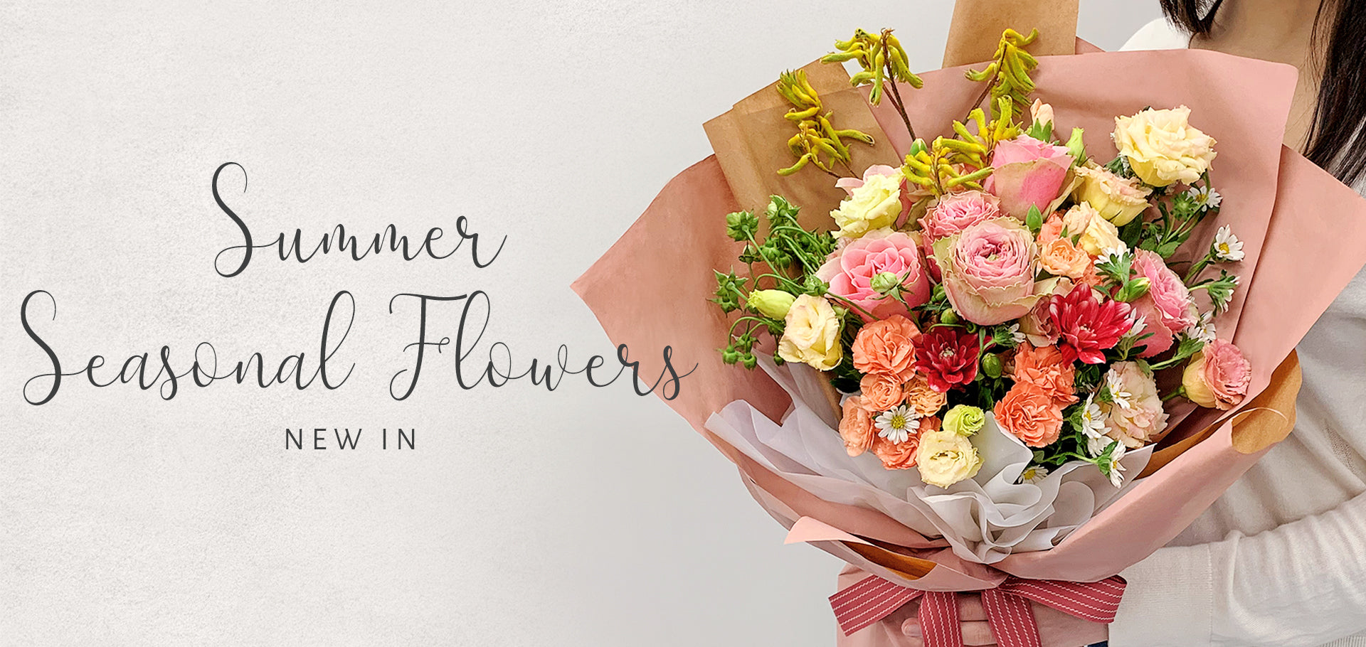 Bouquet of summer seasonal flowers with text 'Summer Seasonal Flowers New In' on a light background